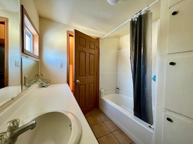 bathroom with tile patterned flooring, vanity, a textured ceiling, and shower / bath combo