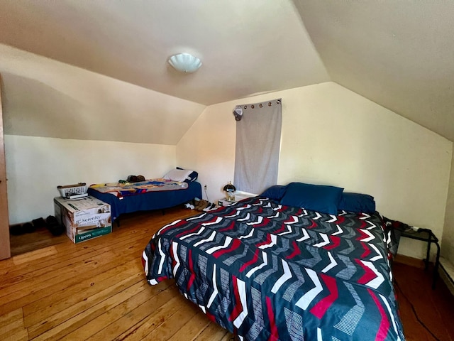 bedroom featuring hardwood / wood-style floors and vaulted ceiling