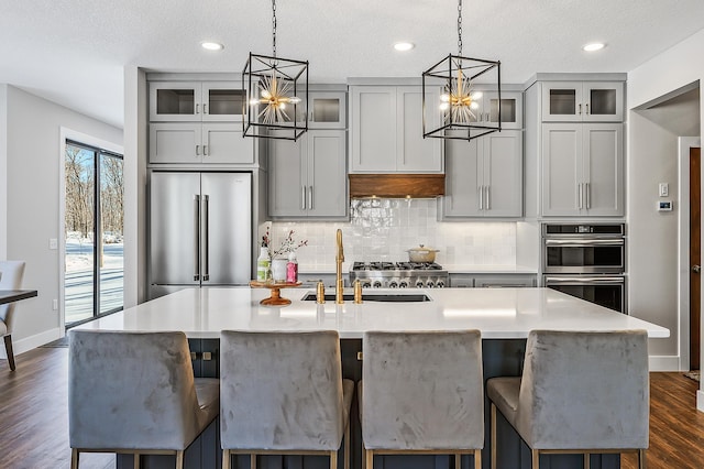 kitchen with a textured ceiling and gray cabinetry