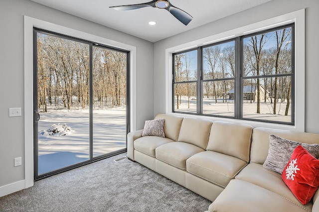 carpeted living room with ceiling fan