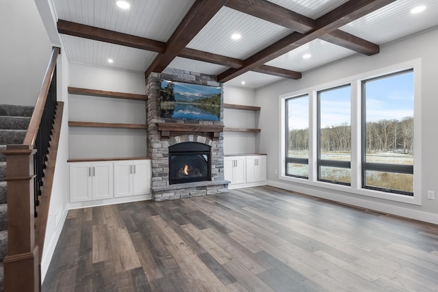 unfurnished living room featuring coffered ceiling, wood ceiling, beam ceiling, hardwood / wood-style floors, and a stone fireplace