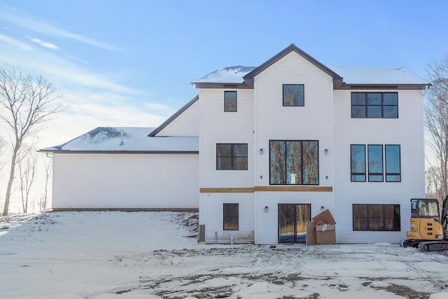 view of snow covered rear of property