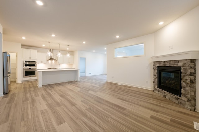 unfurnished living room with light hardwood / wood-style floors and a fireplace