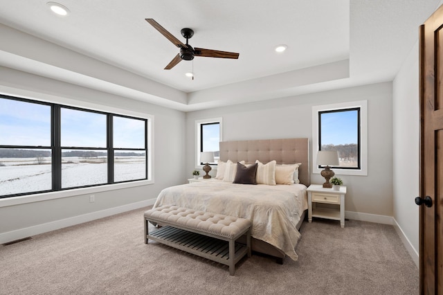 carpeted bedroom with ceiling fan and a water view