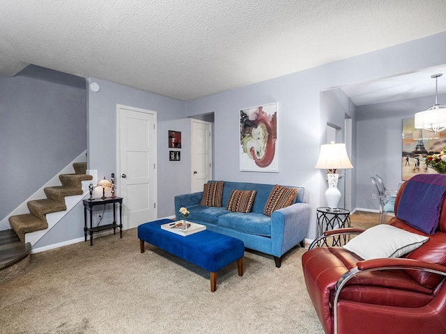 living room featuring carpet floors and a textured ceiling