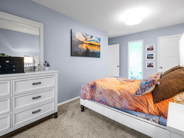 carpeted bedroom featuring a textured ceiling