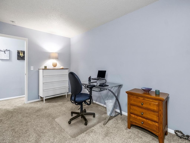 carpeted office space with a textured ceiling