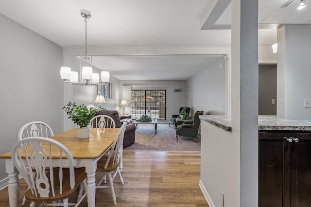 dining area with a chandelier and light hardwood / wood-style floors