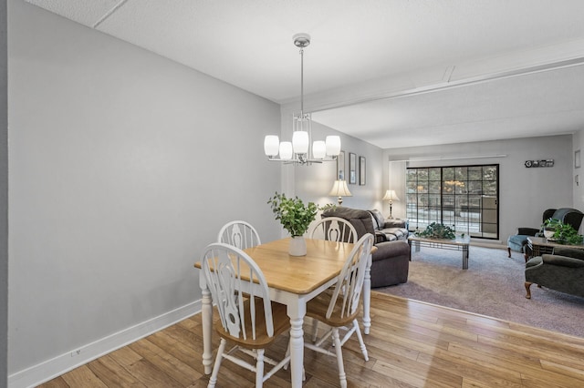 dining space featuring a chandelier and light hardwood / wood-style flooring