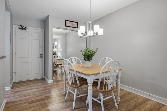 dining area featuring a chandelier and light wood-type flooring