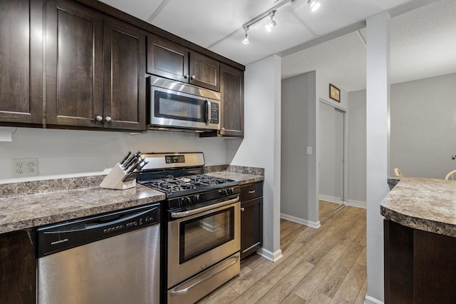 kitchen featuring dark brown cabinetry, stainless steel appliances, and light hardwood / wood-style floors