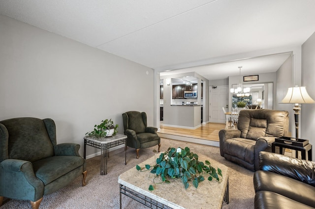 carpeted living room with an inviting chandelier