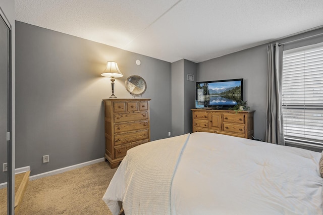 carpeted bedroom with a textured ceiling