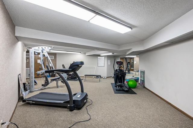 exercise room with carpet and a textured ceiling