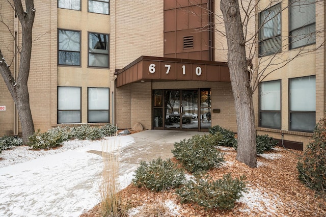 view of snow covered property entrance