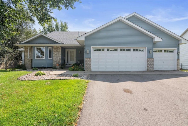 view of front of house with a front yard and a garage