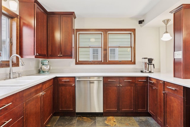 kitchen featuring dark brown cabinets, stainless steel dishwasher, stone finish floor, and a sink