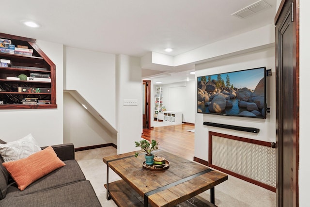 living room with recessed lighting, visible vents, baseboards, and stairs