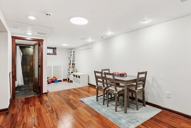 dining area featuring wood finished floors and baseboards