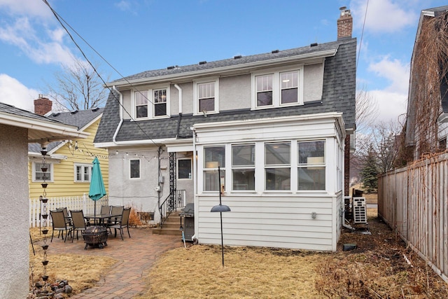 back of house featuring a shingled roof, entry steps, a patio area, and fence