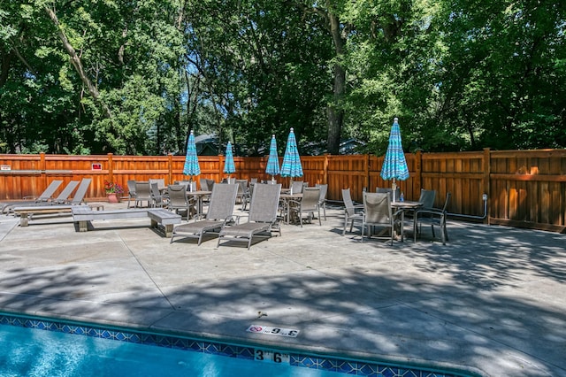 view of patio featuring outdoor dining area and a fenced backyard