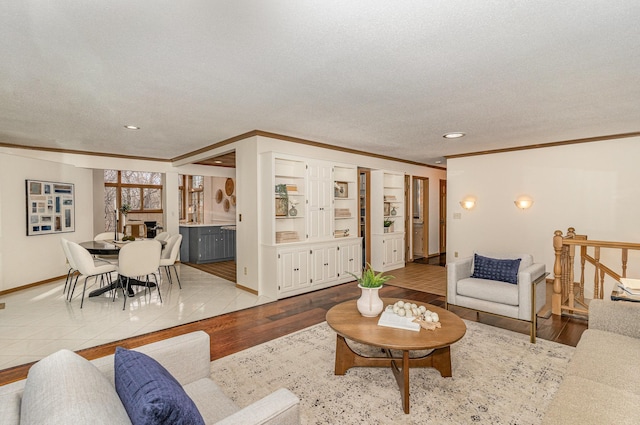 living area featuring a textured ceiling, wood finished floors, and ornamental molding