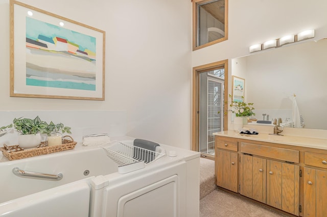 full bath with washer / dryer, a jetted tub, and vanity