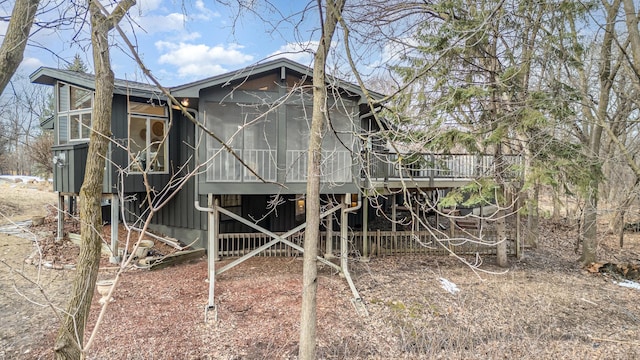 view of outbuilding featuring stairs and a sunroom