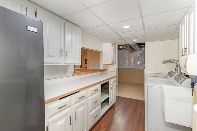 clothes washing area with dark wood finished floors, recessed lighting, cabinet space, and separate washer and dryer