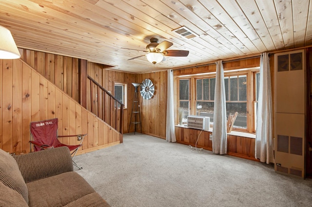 unfurnished room with carpet flooring, ceiling fan, wooden ceiling, and wood walls