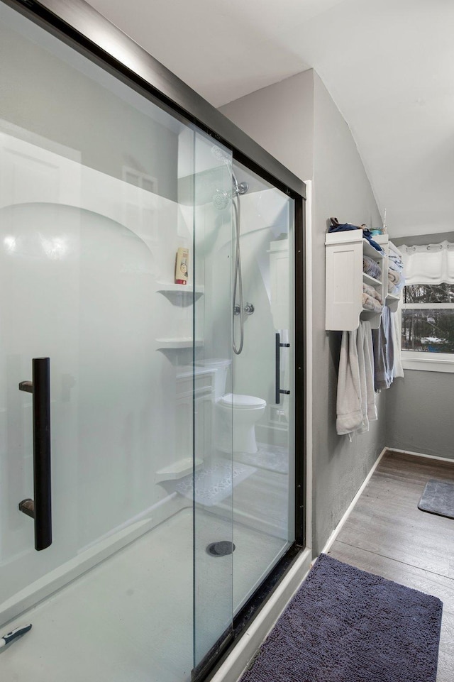 bathroom with wood-type flooring and walk in shower