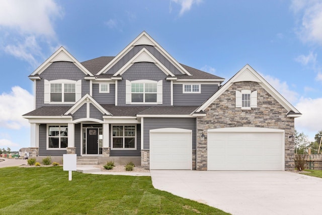 craftsman-style home with a front lawn and a garage