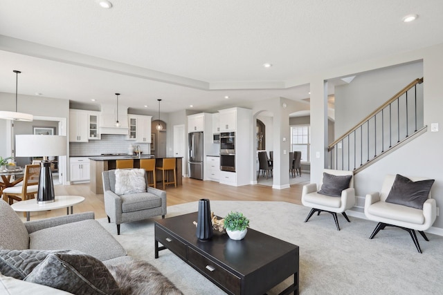 living room with light hardwood / wood-style flooring and sink