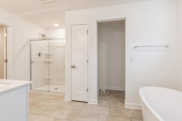 bathroom featuring tile patterned floors, vanity, and separate shower and tub