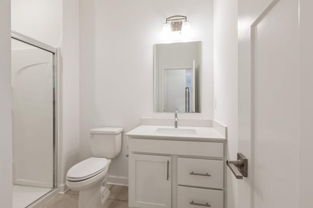 bathroom featuring toilet, vanity, an enclosed shower, and tile patterned floors