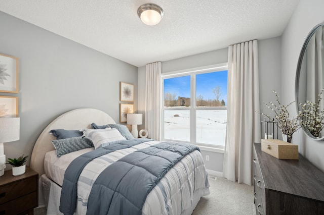 carpeted bedroom featuring a textured ceiling