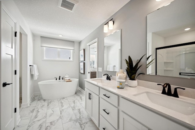 bathroom with vanity, independent shower and bath, and a textured ceiling