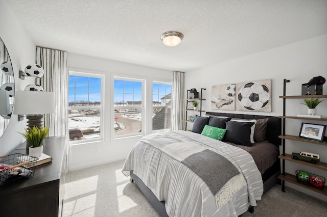 carpeted bedroom featuring a textured ceiling