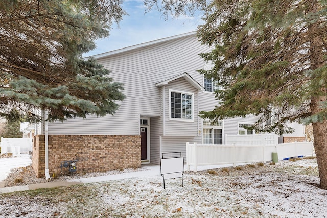 view of snow covered rear of property