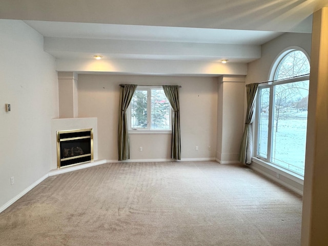 unfurnished living room featuring light carpet