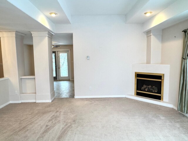 unfurnished living room featuring light colored carpet and ceiling fan