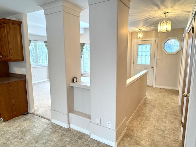 hallway featuring an inviting chandelier