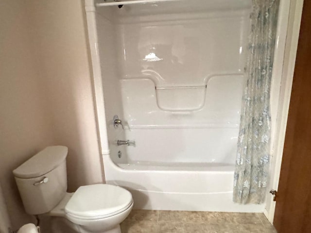 bathroom with toilet and shower / bath combo with shower curtain