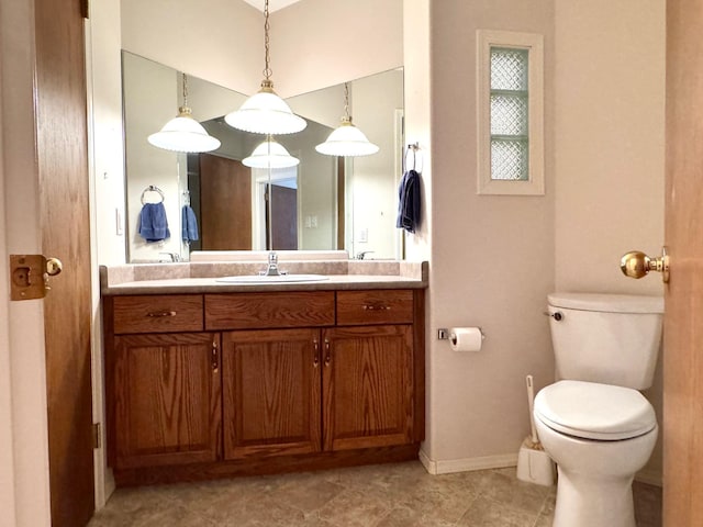 bathroom with tile patterned flooring, vanity, and toilet