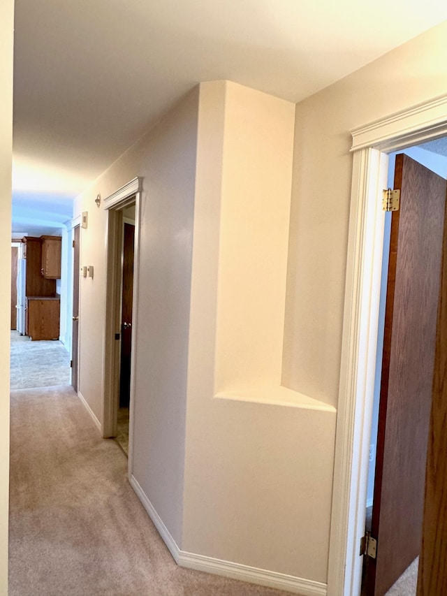 hallway with light colored carpet