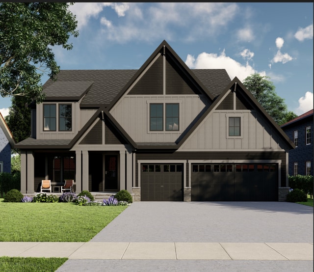 craftsman-style home with a garage and a front lawn