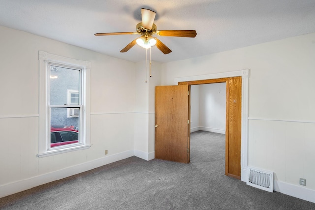 carpeted spare room featuring ceiling fan