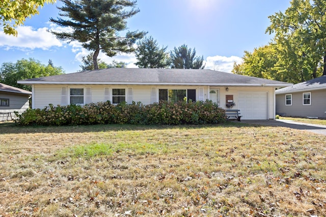 single story home with a garage and a front lawn