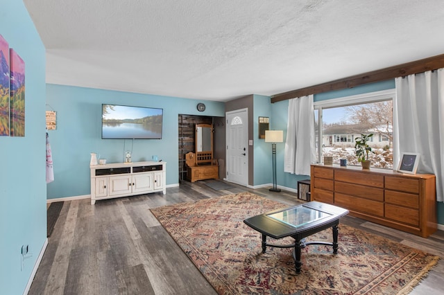 living room featuring dark hardwood / wood-style floors and a textured ceiling