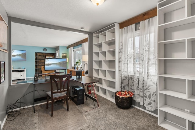 office area with a textured ceiling and carpet floors